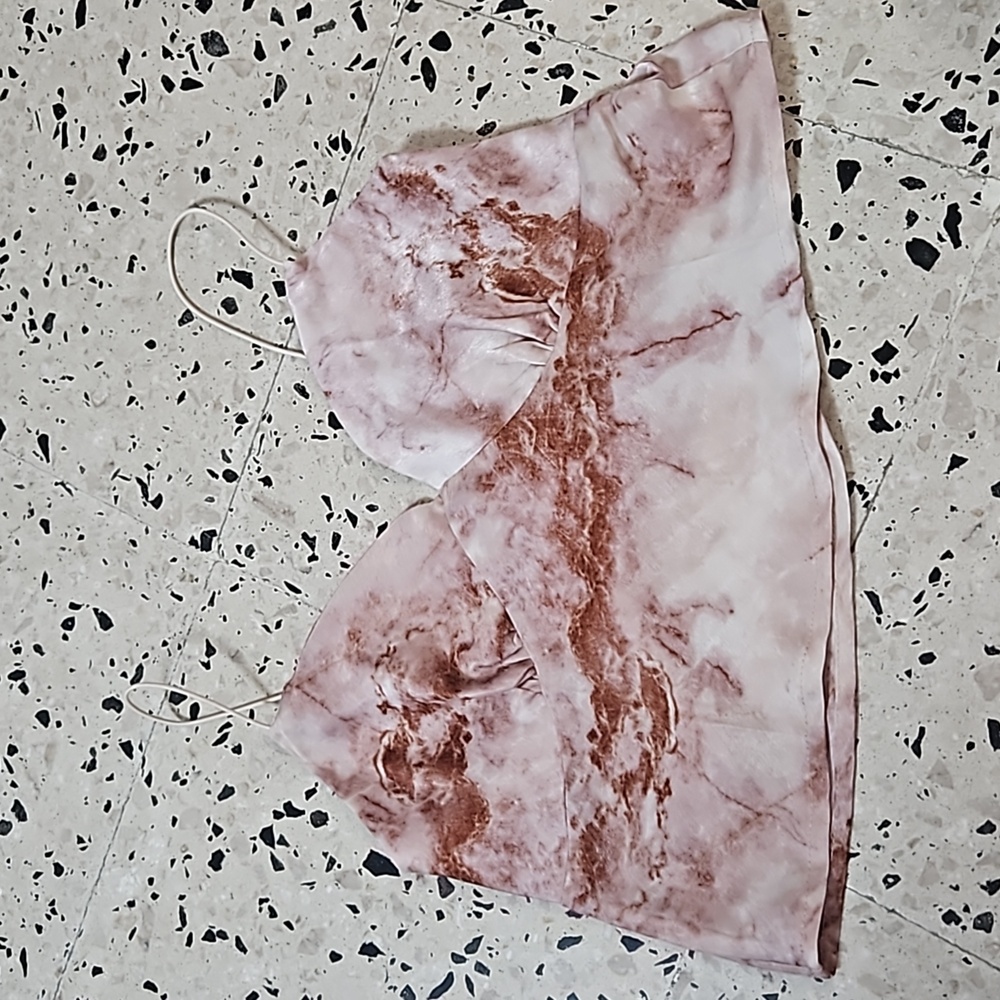 A crop top with a pink marble design